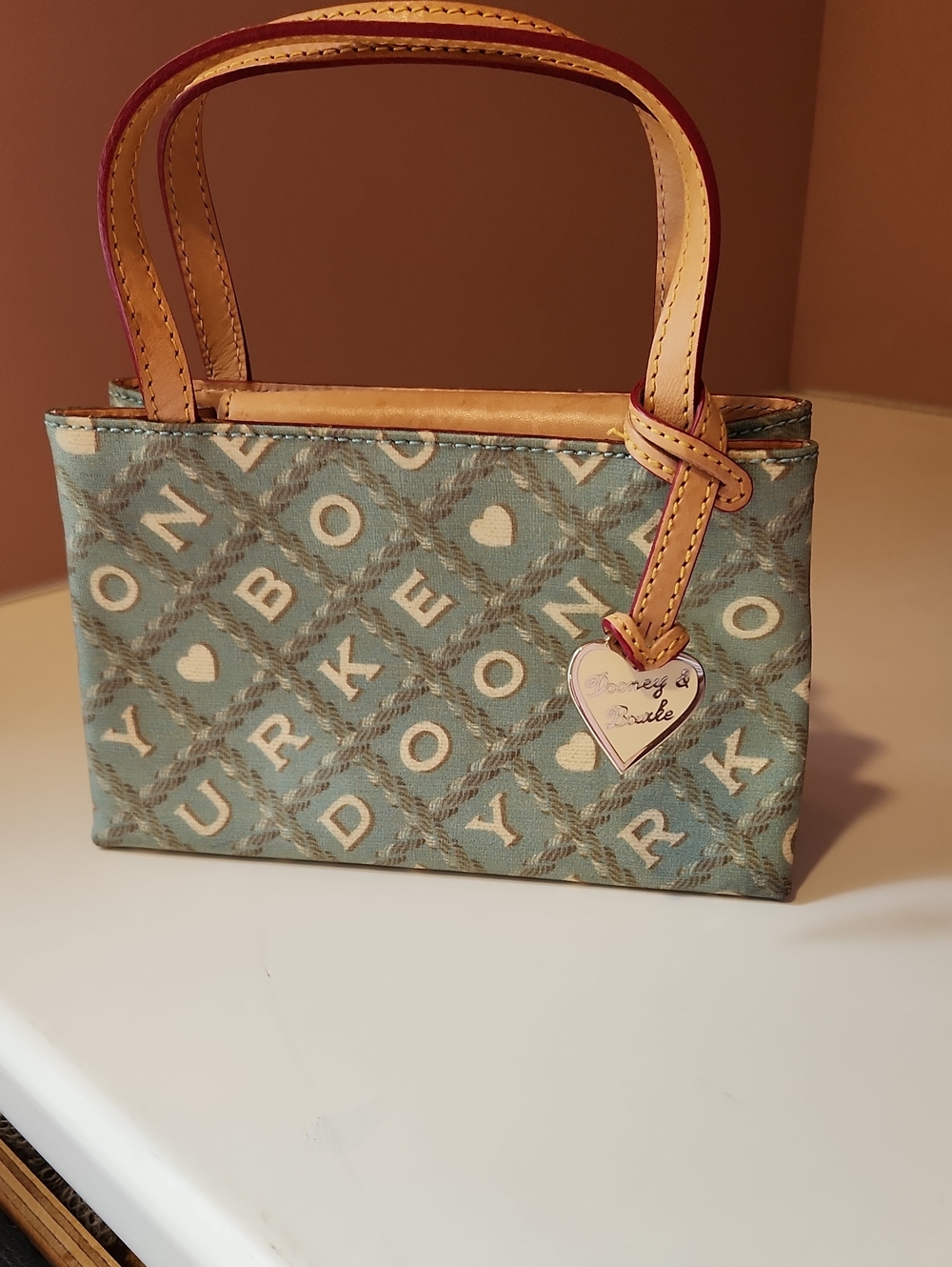 Dooney & Bourke Light Blue/Green Patterned Mini East West Bag with Heart Charm